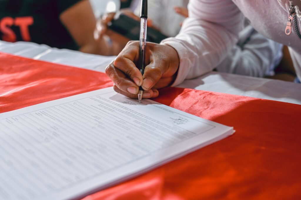 Photograph of a woman signing a document.

Can a notary refuse to notarize a document?